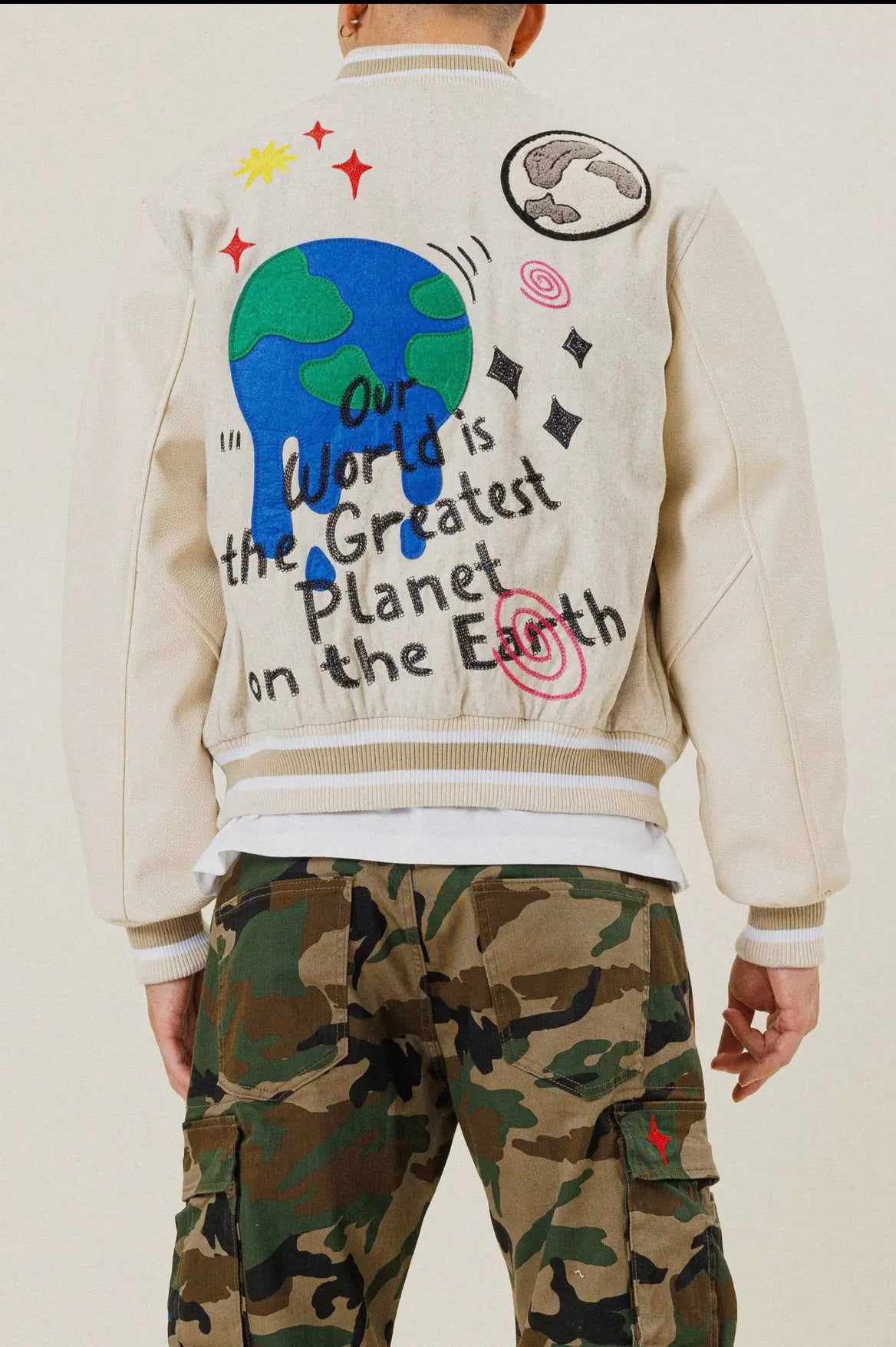 “Our world is the greatest” varsity jacket